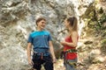 Male and female climber talking and getting ready for the climb