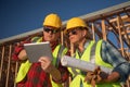 Male and Female Construction Workers Using Computer Pad