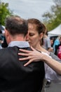 Male and female couple demonstrate a sensual tango dance holding each other closely