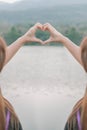 male and female couple showing their hands up to form heart symbol to show friendship love and kindness because heart is symbol of