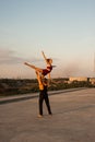 Girl and guy dancers perform a passionate dance together outdoors in nature