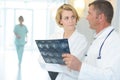 Male and female doctors examining chest x-ray in hospital Royalty Free Stock Photo