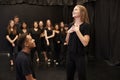 Male And Female Drama Students At Performing Arts School In Studio Improvisation Class Royalty Free Stock Photo