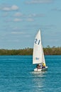 Two early teens sailing on back bay water of the Gulf of Mexico