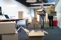 Male and female executives carrying cardboard boxes in office Royalty Free Stock Photo