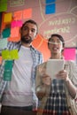 Male and female executives discussing over sticky notes Royalty Free Stock Photo