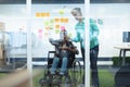 Male and female executives discussing over sticky notes in office Royalty Free Stock Photo