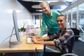 Male and female executives working together on computer at desk in office Royalty Free Stock Photo