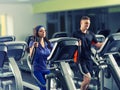 Male and female exercising on the crosstrainer machines