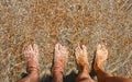 Male and female feet underwater on the seashore. A couple in love on a sea vacation. Royalty Free Stock Photo