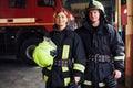 Male and female firefighters in protective uniform standing together Royalty Free Stock Photo