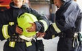 Male and female firefighters in protective uniform standing together Royalty Free Stock Photo