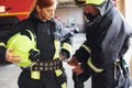 Male and female firefighters in protective uniform standing together Royalty Free Stock Photo