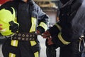 Male and female firefighters in protective uniform standing together Royalty Free Stock Photo