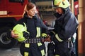 Male and female firefighters in protective uniform standing together Royalty Free Stock Photo