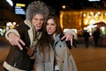 Male and female friends goofing off on the city streets , night out.