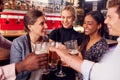 Male And Female Friends Making A Toast As They Meet For Drinks And Socializing In Bar After Work Royalty Free Stock Photo