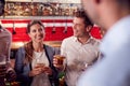 Male And Female Friends Meeting For Drinks And Socializing In Bar After Work Royalty Free Stock Photo