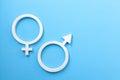 Male and female gender signs on blue background