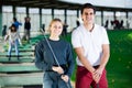 Male and female golfers ready for team play at golf course Royalty Free Stock Photo