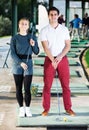 Male and female golfers ready for team play at golf course Royalty Free Stock Photo