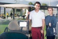 Male and female golfers ready for team play at golf course Royalty Free Stock Photo