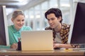 Male and female graphic designer discussing over computer Royalty Free Stock Photo