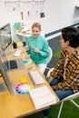 Male and female graphic designer discussing over computer Royalty Free Stock Photo