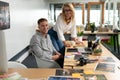 Male and female graphic designers at desk in office Royalty Free Stock Photo