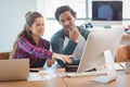 Male and female graphic designers discussing over computer Royalty Free Stock Photo