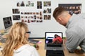 Male and female graphic designers discussing over laptop at desk in office Royalty Free Stock Photo