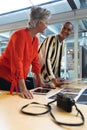 Male and female graphic designers discussing over photographs at desk Royalty Free Stock Photo