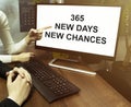 Male and female hand, computer with text 365 New Days New Chances with office background