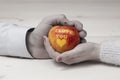 Male and female hand holding an apple with I love you inscription Royalty Free Stock Photo