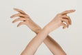 Male and female hands demonstrating a gesture of getting touch isolated on gray background