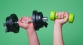 Male and female hands with dumbbells close-up. Training muscles. Female and male hand holds dumbbell. Muscular hands Royalty Free Stock Photo