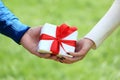 Male and female hands with gift box