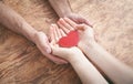 Male and female hands holding red heart Royalty Free Stock Photo