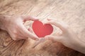 Male and female hands holding red heart Royalty Free Stock Photo