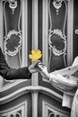 Male and female hands holding a yellow maple leaf on the black and white background Royalty Free Stock Photo