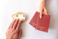 Male and female hands with passport and money on white background