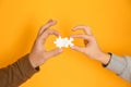 Male and female hands with pieces of puzzle on color background Royalty Free Stock Photo