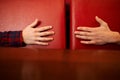 Male and female hands are reach to each other on a red background. concept of care, support, love. toning