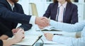 Male and female handshake in office close-up. Serious business and partnership concept. Partners made deal, sealed with