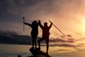 Male and female hikers climbing up mountain cliff and one of them giving helping hand Royalty Free Stock Photo