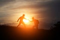 Male  hikers climbing up mountain cliff and one of them giving helping hand. Royalty Free Stock Photo