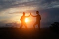 Male hikers climbing up mountain cliff and one of them giving helping hand. Royalty Free Stock Photo