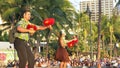 A male and female hula dancer with uliuli perform at waikiki beach Royalty Free Stock Photo