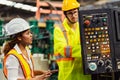 Female industrial engineer standing in a heavy industrial factory