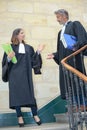 Male and female lawyers talking in stairs